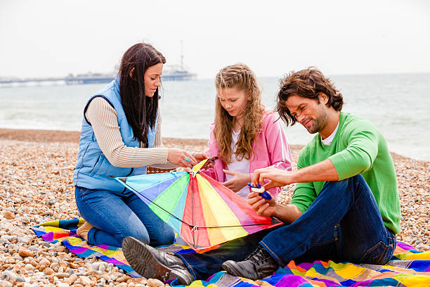 istock Mother, Father and Daughter with a Kite 506444280