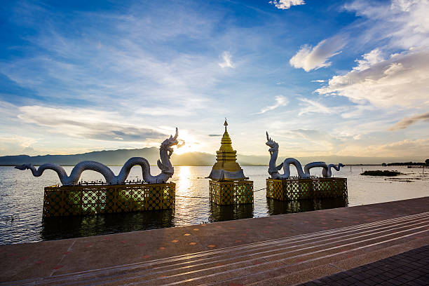 istock Silhouettes dragon and Naga statue on sunset 506445666