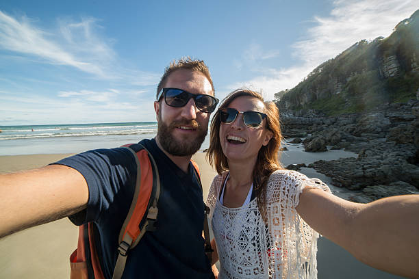 istock Cheerful young couple take selfie portrait on beach 506446384