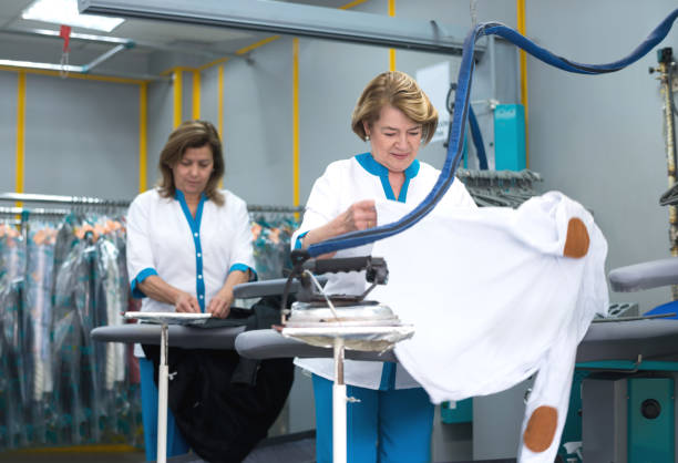 istock Women ironing clothes at a laundry shop 506447196