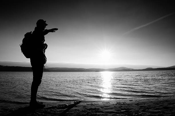 istock Man with hand in air. Hiker in sportswear with backpack 506447802