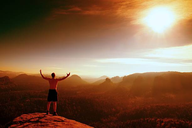 istock Red filter photo. Naked climber. Tourist on sharp sandstone rock 506447868