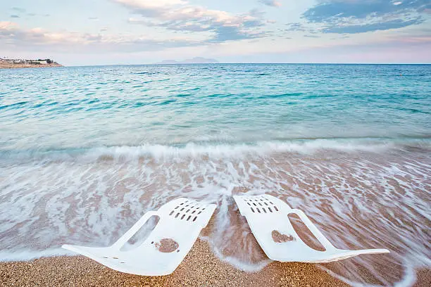 Landscape of Two Lonely beachchairs near the sea in the morning at a perfect beach in Egypt