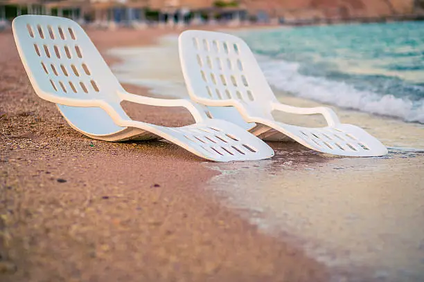 Landscape of Two Lonely beachchairs near the sea in the morning at a perfect beach in Egypt