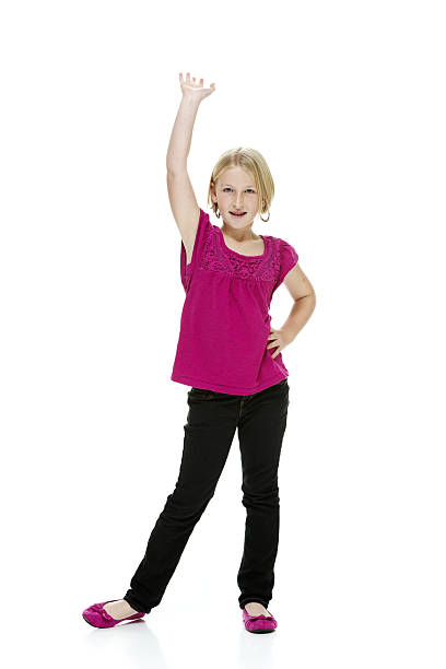 istock Smiling girl standing & waving hand 506469415