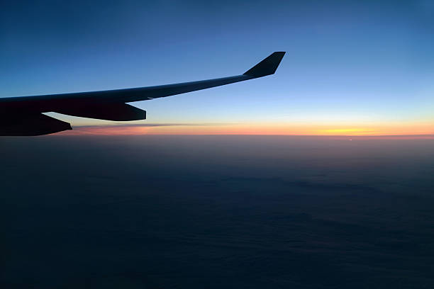 istock Silhouette of plane wing at sunrise 506469765