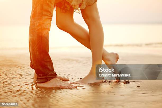 Loving Young Couple Hugging Kissing On The Beach At Sunset Stock Photo - Download Image Now