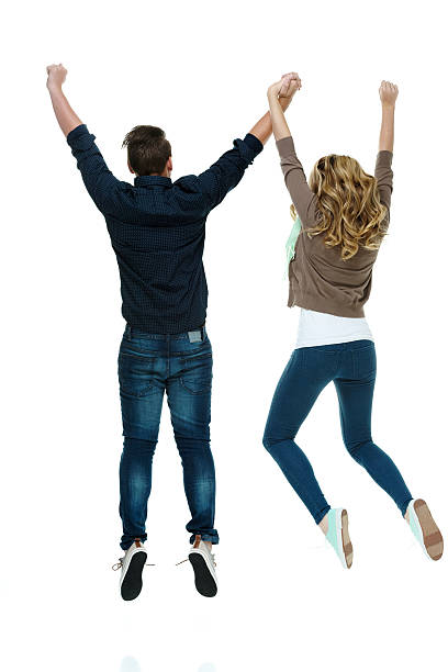 istock Rear view of couple jumping & cheering 506470213