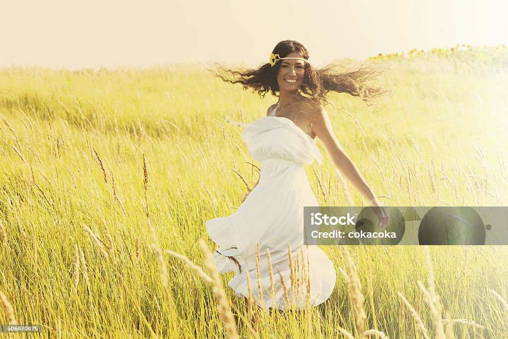 summer spirit happy smiling woman in boho style clothes run  through the field, sunny summer day, retro colors Adult Stock Photo