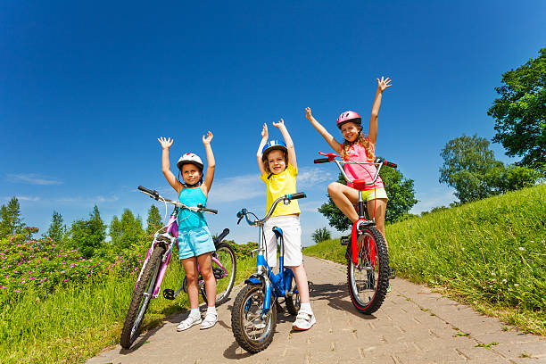 istock Three little girls on a bikes outsides 506470913