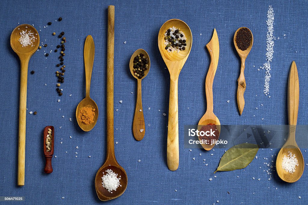 Spices Salt, pepper, turmeric and paprika in wooden spoons Bay Leaf Stock Photo