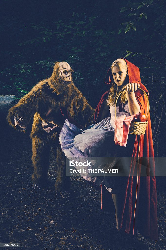 Little Red Riding Hood kicking bigfoot Little Red Riding Hood (the sequel) got a new enemy, enter bigfoot. but she is taking care of him too. Adult Stock Photo