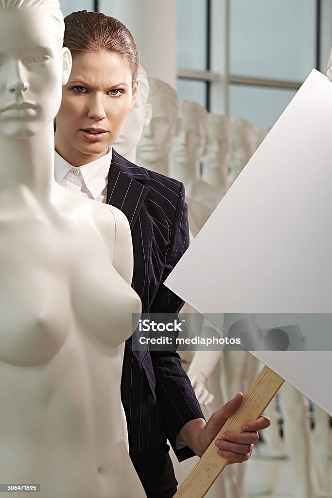strike female striker standing among mannequins 20-24 Years Stock Photo