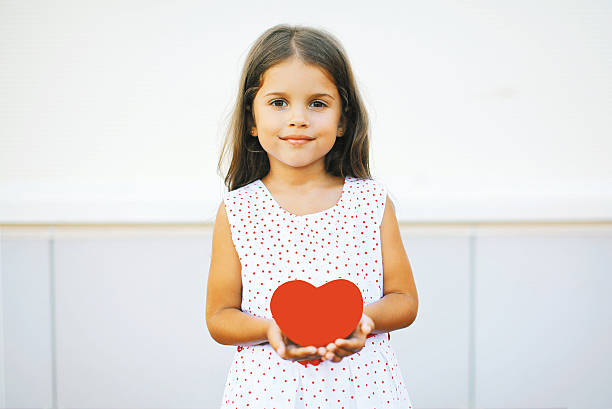 Little girl with red heart