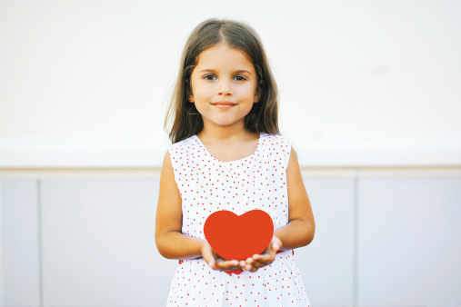 Little girl with red heart