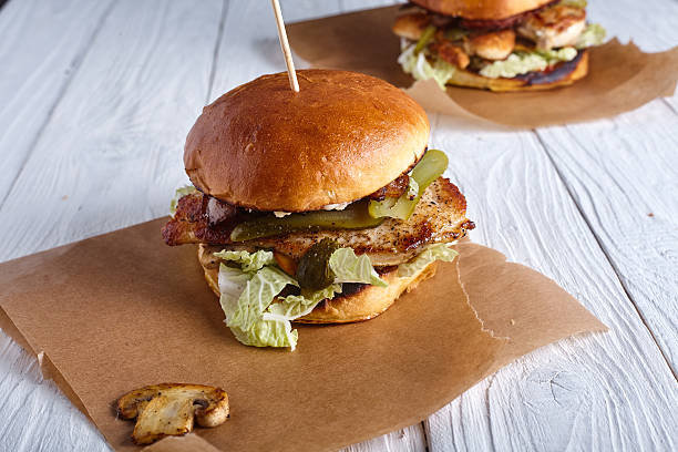 istock Burger with chicken, cheese sauce and mushrooms 506472216