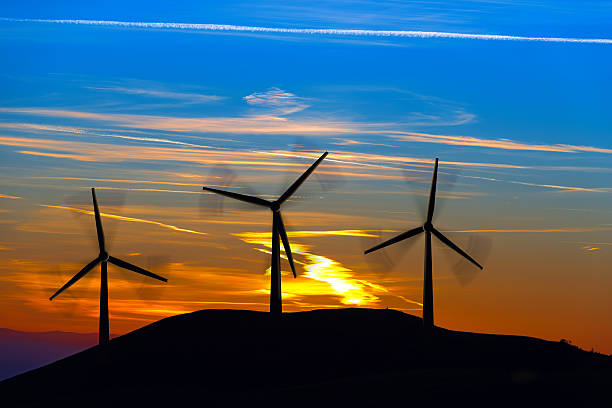 istock Silhouettes of Wind Turbines at Sunset 506472234