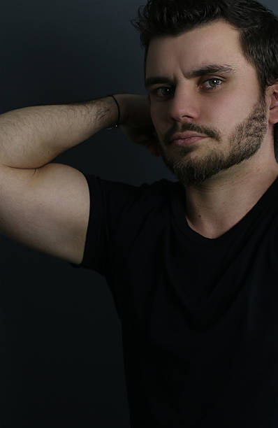 istock young man showing his bicep 506472282