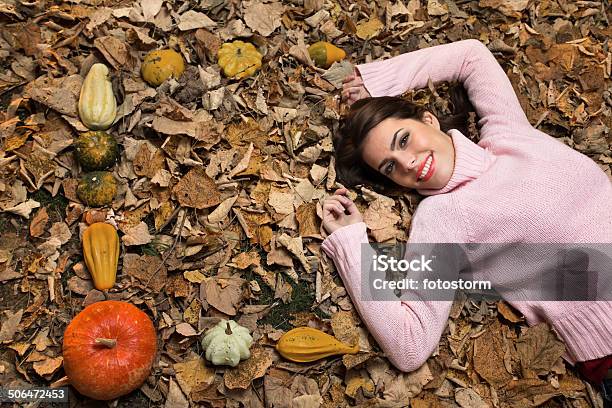 Young Woman Lying Down On Autumn Leaves Stock Photo - Download Image Now - Adult, Adults Only, Autumn