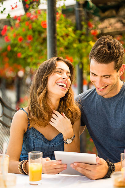 istock Couple watching something funny on digital tablet 506473860