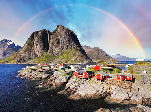 Norwegian fishing village huts with rainbow, Reine, Lofoten Islands, Norway