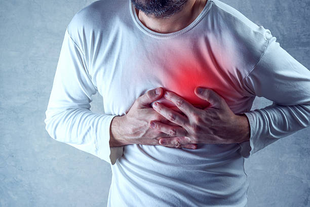Severe heartache, man suffering from chest pain, having painful stock photo