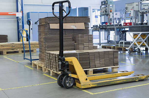 istock Pallet truck is standing in the assembly hall 506477780
