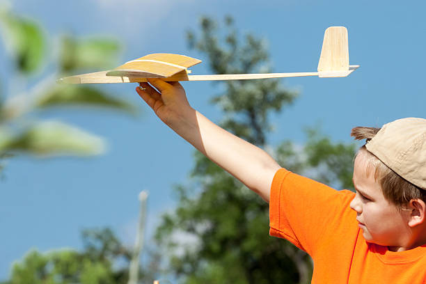 istock Little boy playing with handmade RC airplane toy 506477906