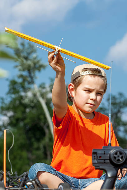 istock Little boy playing with handmade RC airplane toy 506477974