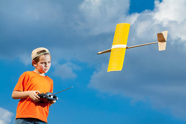 Little boy playing with handmade RC airplane toy