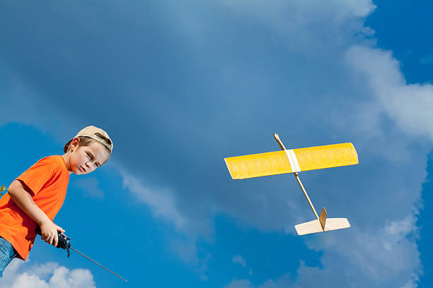 istock Little boy playing with handmade RC airplane toy 506478248