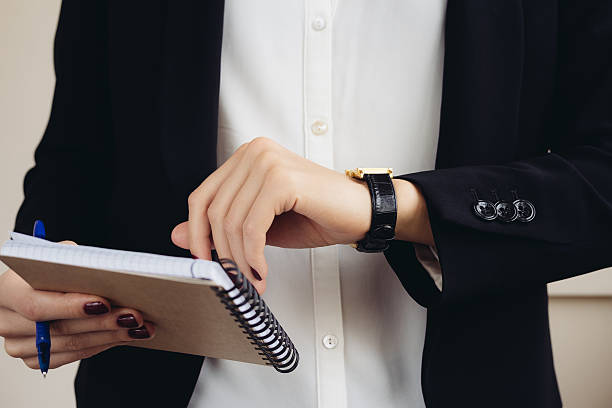istock Woman in a business suit holding a notebook 506478520