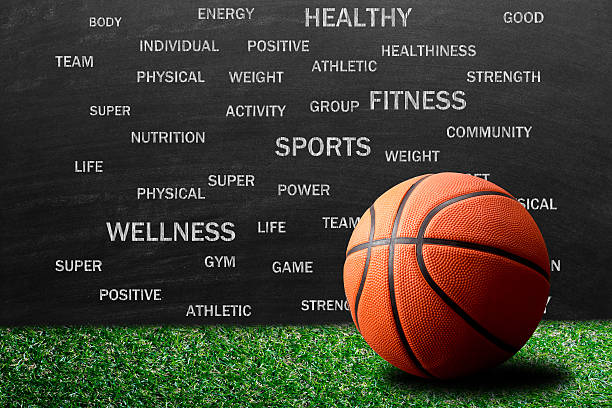 Healthy lifestyle and education Close up of an orange basket ball against blackboard on which word cloud containing words related to healthy lifestyle. sports the best bookies code stock pictures, royalty-free photos & images