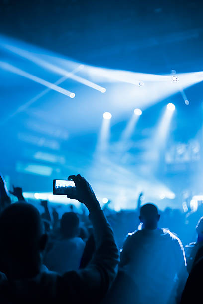 istock taking pictures  during a music concert 506482084