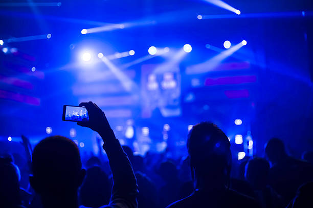 istock taking pictures  during a music concert 506482704