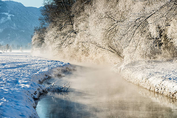 istock winter landscape with steamy river at sunrise 506483238