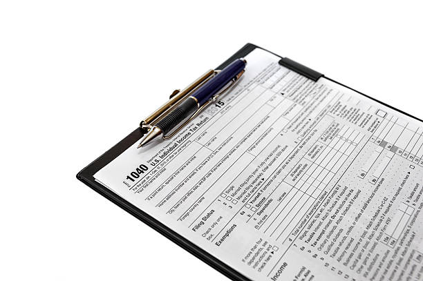 istock US tax form with pen on clipboard isolated on white 506483274
