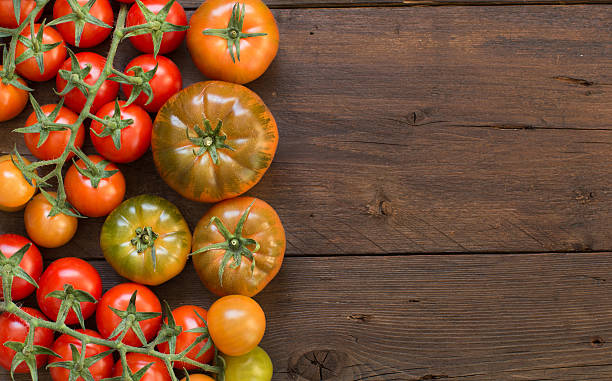 istock Fresh tomatoes on a wooden background 506483432