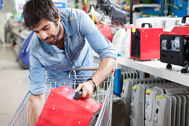 Man shopping hardware store Male customer buying calorifier at hardware store space heater stock pictures, royalty-free photos & images