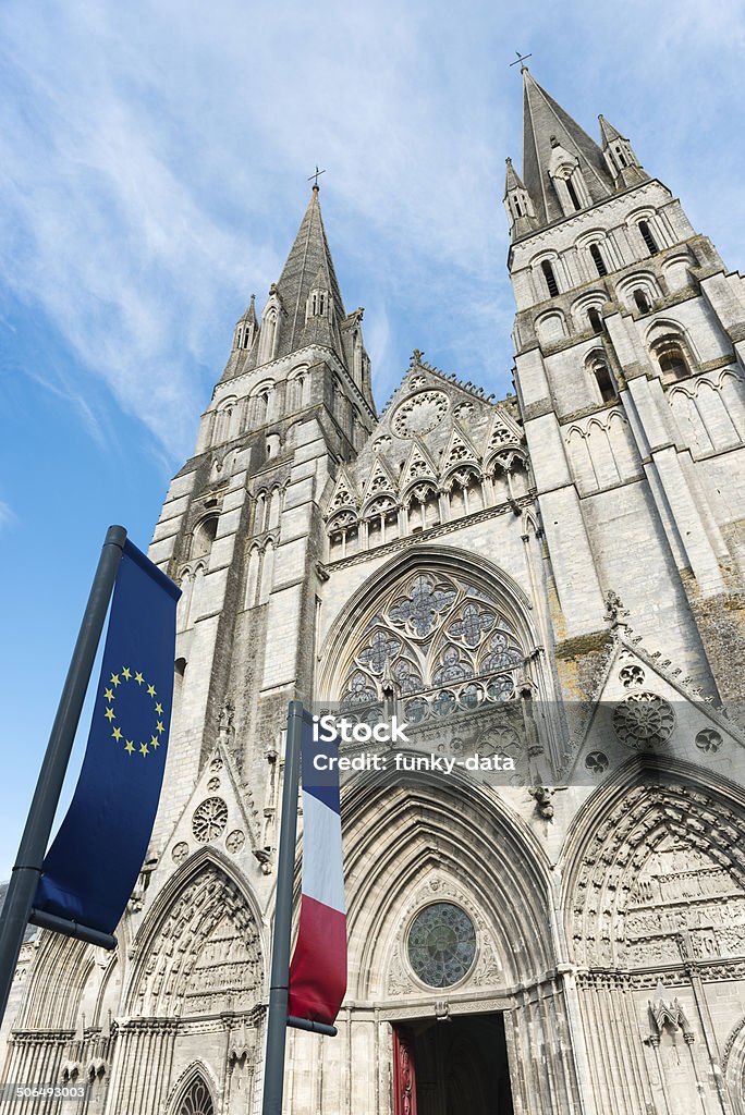 Cathedral of Bayeux Cathedral of Bayeux with French and EU flags. Architecture Stock Photo