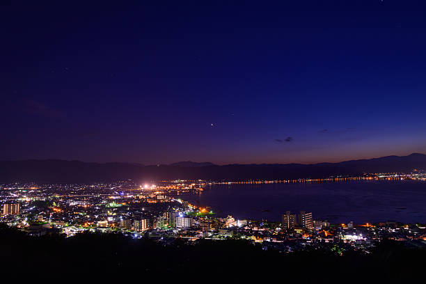 Night view of the city of Suwa Night view of the city of Suwa. The Suwa region is the leading industrial area of Nagano and was once known as "The Oriental Switzerland" for its highly developed precision machinery industry. suwa lake photos stock pictures, royalty-free photos & images