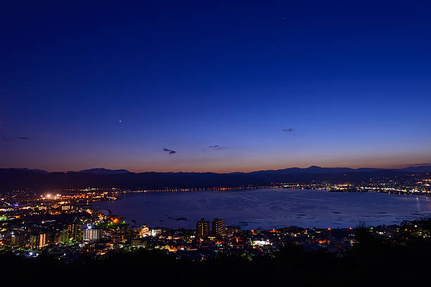 Night view of the city of Suwa Night view of the city of Suwa. The Suwa region is the leading industrial area of Nagano and was once known as "The Oriental Switzerland" for its highly developed precision machinery industry. suwa lake photos stock pictures, royalty-free photos & images