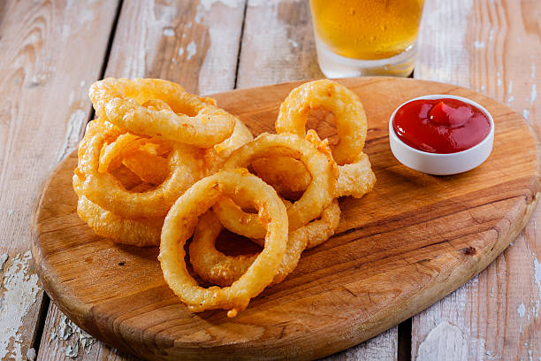 istock fried onion rings with red sauce 506496591