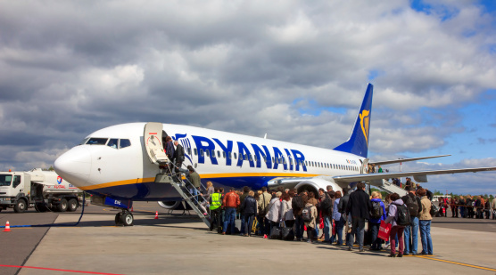 Vilnus, Lithuania - May 2, 2014: People boarding a Ryanair on the route Vilnius - Paris (Beauvais). Ryanair is one of the largest low-cost European airline by scheduled passengers carried.