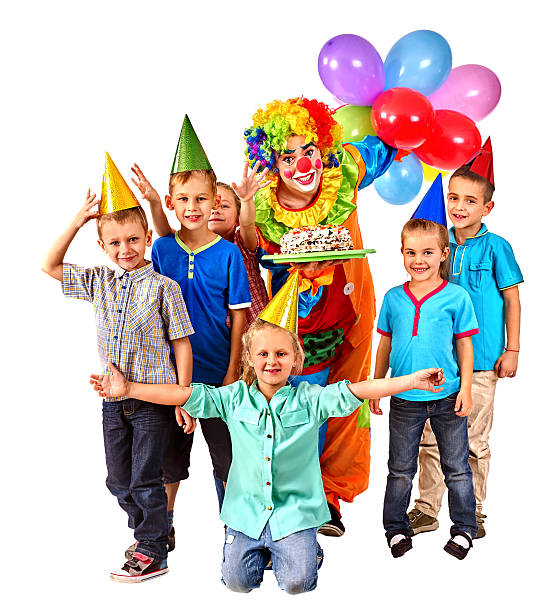 Clown holding cake and balloons on birthday with group children. Isolated.