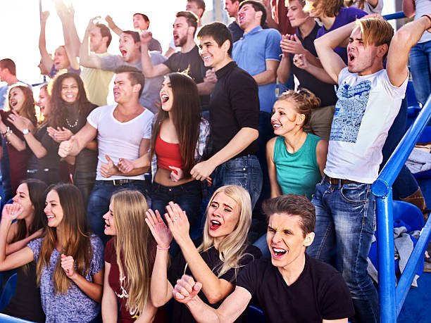 istock Sport fans clapping and singing on tribunes 506504260