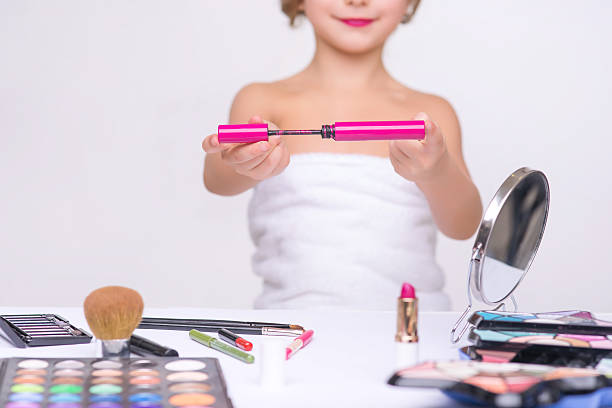 istock Nice little girl doing make up 506504382