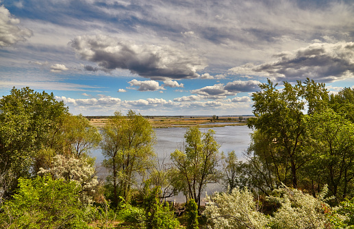 View of the Volga River from the high coast in the summer, the beautiful sky and clouds