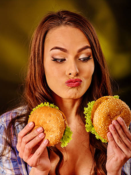 大きなサンドイッチを食べる少女 - large cheese beautiful red ストックフォトと画像