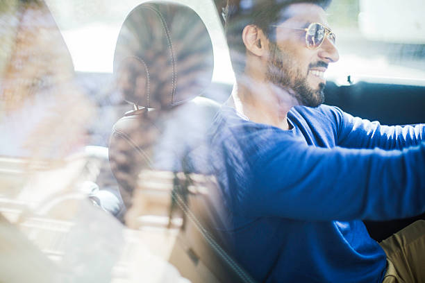 Middle eastern couple driving a luxury car in Dubai One beautiful couple driving a car. fashionable dad stock pictures, royalty-free photos & images